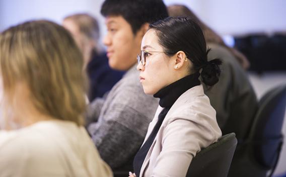 Woman listening to a presentation.